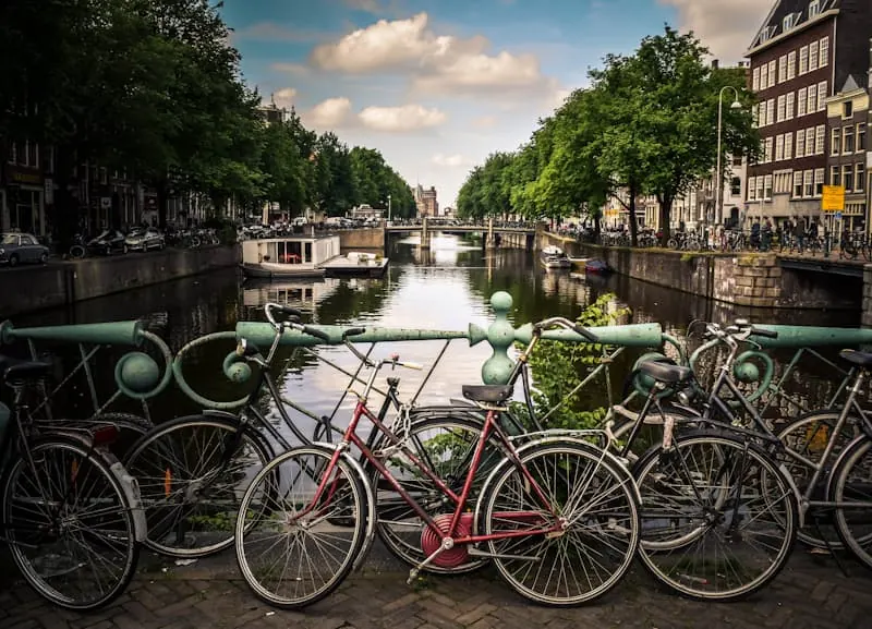 Bicycles along a blue railing