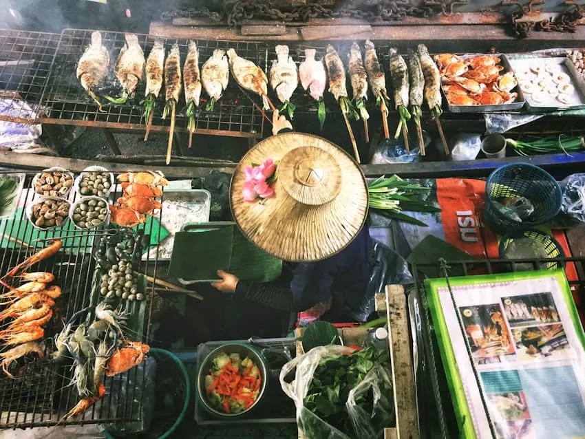 A vendor in a conical hat at first light